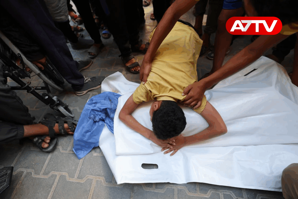 A boy leans over the body of his cousin after he was killed in an Israeli strike that hit Nuseirat in central Gaza on July 13. Eyad Baba/AFP/Getty Images