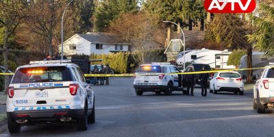 Fraser Heights, Surrey, Vancouver, British Columbia, Canada - February 6, 2022: Police and Swat Team are arresting a man for alleged Robery. Suburban Neighborhood during sunny Sunday morning.